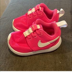 Hot pink Nike tennis shoes
